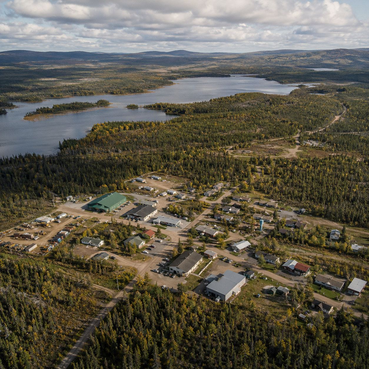 Aerial view of a community set among forest and lakes
